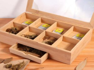 Wooden tea box organizer made of bamboo with clear acrylic lid, featuring multiple compartments for storing and organizing tea bags.